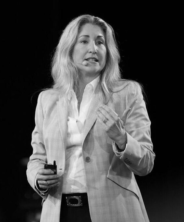 Tiffani Bova speaking on stage, black and white photo